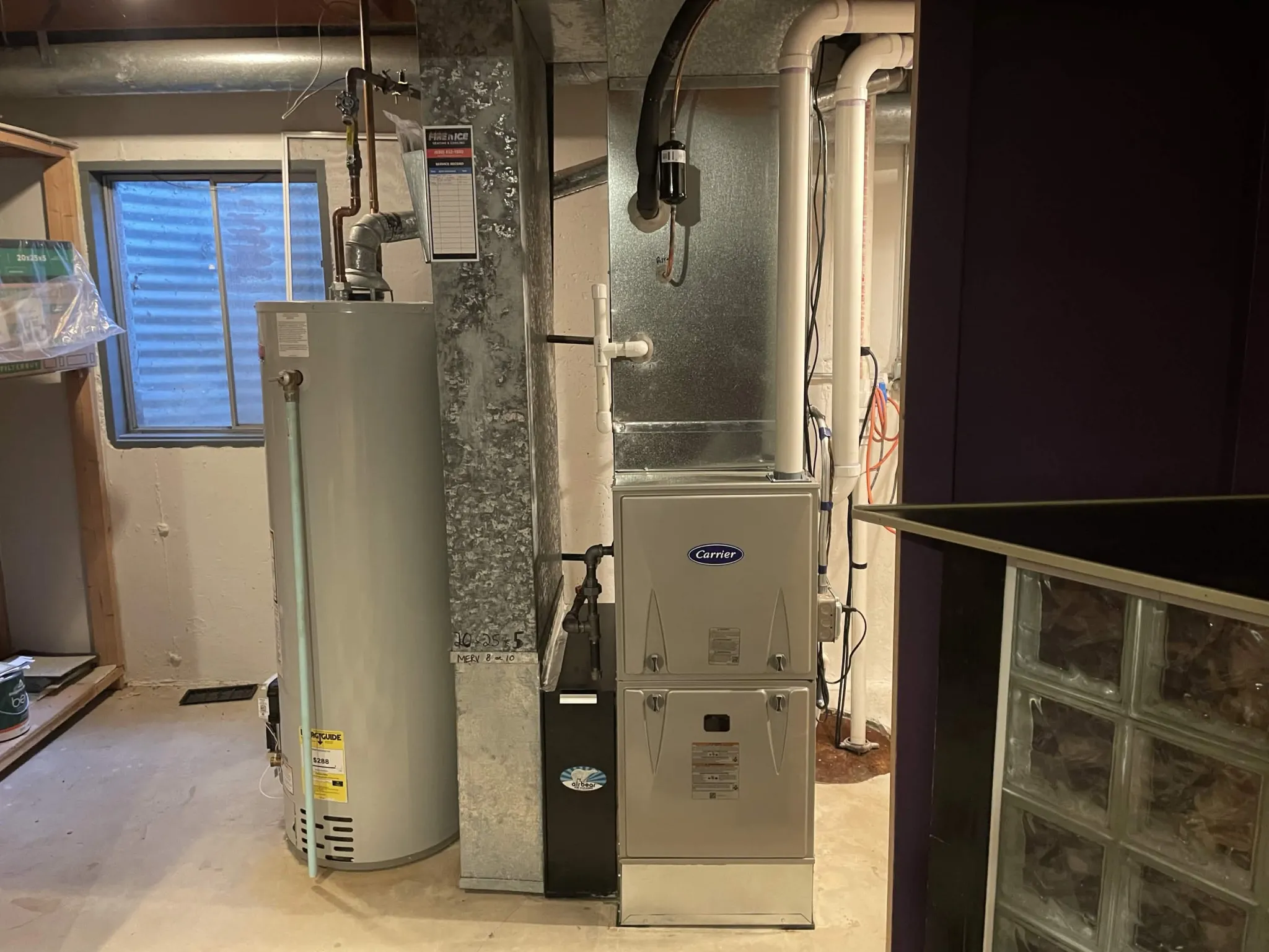 New Carrier high-efficiency furnace installed by Fire 'n' Ice in a Naperville, IL basement with PVC venting and a media air cleaner